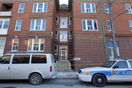 Police identification unit and many other police cars remain at the apartment at 270 Morley Ave. where a body was found over the weekend. December 5, 2011(BORIS MINKEVICH / WINNIPEG FREE PRESS)