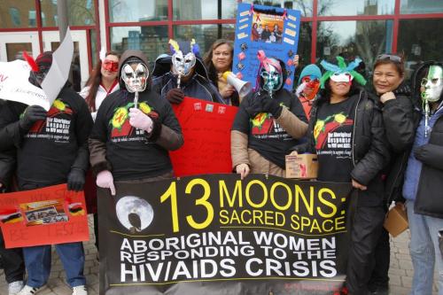 Aboriginal women bringing awareness to HIV/Aids gather behind Portage Place to march and give info and condoms to people on and around Portage Ave. The group had a smudge before they started. December 6, 2011(BORIS MINKEVICH / WINNIPEG FREE PRESS)