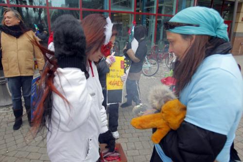 Aboriginal women bringing awareness to HIV/Aids gather behind Portage Place to march and give info and condoms to people on and around Portage Ave. The group had a smudge before they started. December 6, 2011(BORIS MINKEVICH / WINNIPEG FREE PRESS)