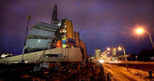 The construction site for the Canadian Museum for Human RIghts glows at dusk up the road from the the 1st Annual Public meeting . See Carol Sander's tale. December 6, 2011 - (Phil Hossack / Winnipeg Free Press) CMHR