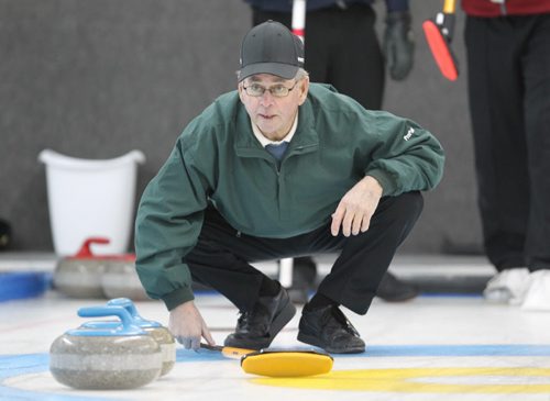 Brandon Sun 07122011 Marty More guides in a rock during his rinks match against Murray Duncan's rink in the Masters Super League of Curling at the Riverview Curling Club on Wednesday.  (Tim Smith/Brandon Sun)