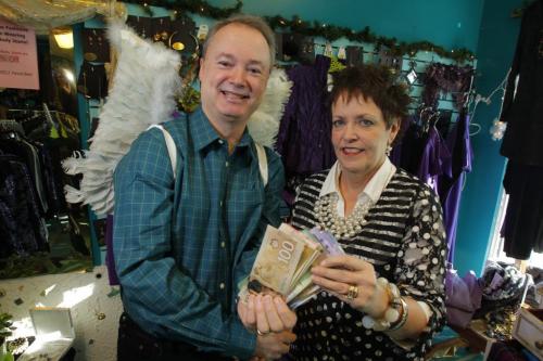 Pennies for Heaven Peppertree owner Connie Hall hands over thousands of dollars to Kevin Rollason. They raised the money at a fashion show they had.  December 9, 2011 BORIS MINKEVICH / WINNIPEG FREE PRESS