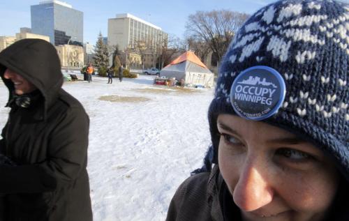 Occupy Winnipeg update. After cleaning out camp a small group of tents and occupiers hold tight on the grounds across from the Manitoba Legislature Building.  Pam Godin has a pin on her hat. She is one of the coordinators of Occupy Winnipeg. December 11, 2011 BORIS MINKEVICH / WINNIPEG FREE PRESS
