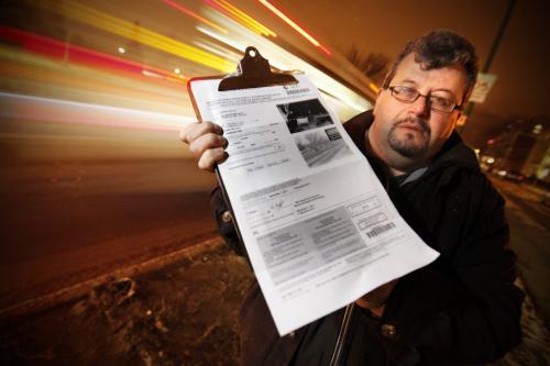 December 12, 2011 - 111212  -  Eric Zipman poses with a speed camera ticket Monday, December 12, 2011 he received on Grant at Nathaniel.  John Woods / Winnipeg Free Press