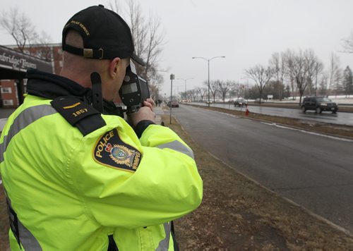 Const. Ray Howes of the Winnipeg Police Service shows use of traditional laser speed gun near the intersection of Grant and Nathaniel - See Bruce Owen story December 14, 2011   (JOE BRYKSA / WINNIPEG FREE PRESS)