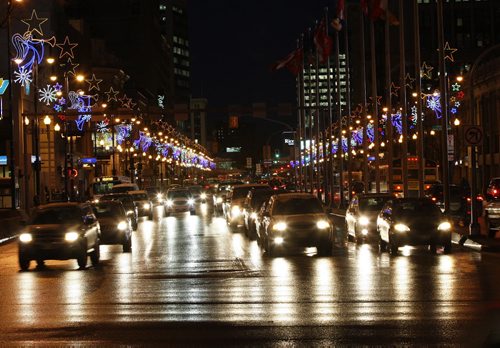 STDUP weather - Rush Hour drivers  were  treated  to main routes that  have been sanded and salted  after  yesterday's freezing rain . Traffic is moving smoothly although roads are wet  and drivers have to drive to conditions . Portage Ave  and Main St with Christmas lights reflecting with headlights on the  wet roads and -7 c - KEN GIGLIOTTI /  WINNIPEG FREE PRESS /  Dec. 15 2011