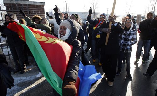 A large group of Eritrean demonstrators marched outside of the Winnipeg Free Press Thursday afternoon protesting a story that appeared in the paper . Managing Editor Margo Goodhand  met with the group outside the Free Press  and listened to their compliant . The peaceful protest was interrupted  for a brief  time a  small group in a car that antagonized the demonstrators . Police quickly moved in a with organizers to break up the disruption .The group left ended the demo a short time later and  left the  Wpg Free Press without incident . - KEN GIGLIOTTI /  WINNIPEG FREE PRESS /  Dec. 15 2011