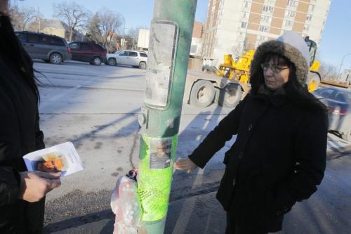 At the corner of Sherbrook and Portage Ave. where Eddy Bone where he got hit by a car. In photo: daughter Barbara Bone with the memorial. December 15, 2011 BORIS MINKEVICH / WINNIPEG FREE PRESS