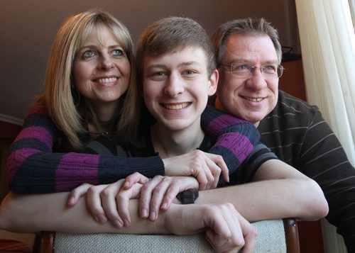 Abram Thiessen with his parents Karen and Richard Abram survived after his heart stopped for 45min at St Boniface Hospital last week and his fellow students at CMU held prayer vigils for him- See Gordon Sinclair story-December 15, 2011   (JOE BRYKSA / WINNIPEG FREE PRESS)