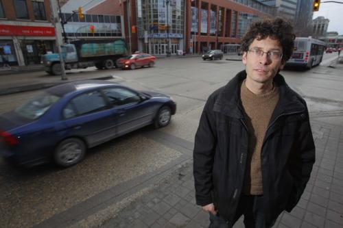 Josh Brandon from the Green Action Centre poses for a photo on Portage Ave. and Donald Street. He is promoting a pay-as-you-drive insurance program currently used in other provinces. Nick Ashdown story.
December 20, 2011 BORIS MINKEVICH / WINNIPEG FREE PRESS
