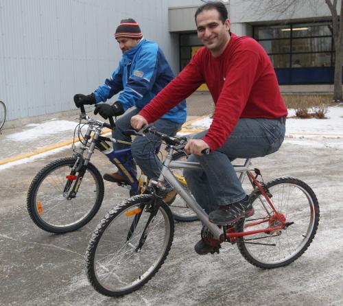 Altona, Manitoba- Qasem Eid , rear in blue, and his brother Wesam are both Palestinian refugees that live in work in Altona, Manitoba-Because they live in a small town with no public transportation, the two use bicycles year- round to get about- See Bill Redekop story December 21, 2011   (JOE BRYKSA / WINNIPEG FREE PRESS