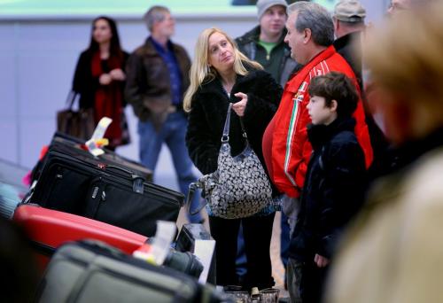 Deborah Demoskoff and her father Vic, wait for her baggage Thursday morning at Richardson Int'l Airport. See story re: busy travel day..... December 23, 2011 - (Phil Hossack / Winnipeg Free Press)