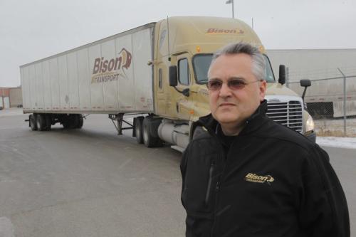 Bison Trucking Garth Pitzel poses for a photo at the security gates at the company's yard on Sherwin Road. December 23, 2011 BORIS MINKEVICH / WINNIPEG FREE PRESS