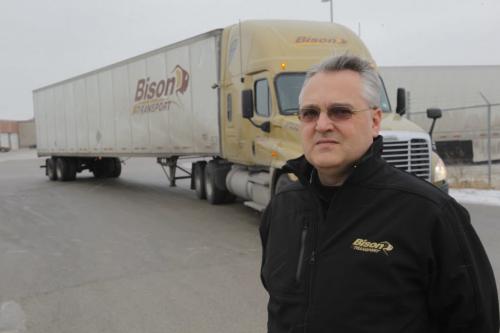Bison Trucking Garth Pitzel poses for a photo at the security gates at the company's yard on Sherwin Road. December 23, 2011 BORIS MINKEVICH / WINNIPEG FREE PRESS