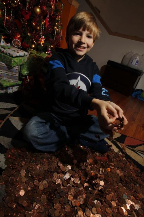 Titus Stewart,8, raised almost double his weight in pennies for the Pennies from Heaven drive. December 23, 2011 BORIS MINKEVICH / WINNIPEG FREE PRESS