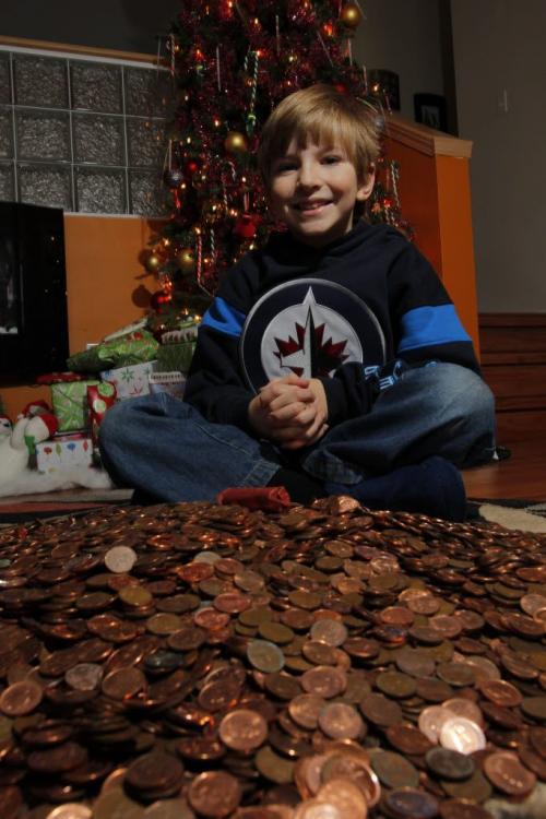 Titus Stewart,8, raised almost double his weight in pennies for the Pennies from Heaven drive. December 23, 2011 BORIS MINKEVICH / WINNIPEG FREE PRESS