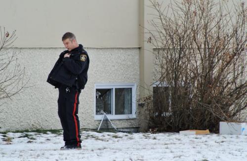 A Winnipeg Police Officer attends to a vandalism call at Monroe Jr. High School where about a dozen windows were smashed in. It is not known at this time if anything was stolen from the school. 111224 Mike Deal / Winnipeg Free Press