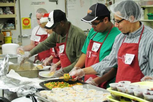 Volunteers put together turkey dinners in the kitchen at Siloam Mission during the annual Christmas meal. Ninety volunteers will serve around 700 plates of food today, up from past years.  111224 Mike Deal / Winnipeg Free Press