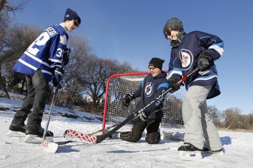 December 25, 2011 - 111225  -  Rob Finlay plays hockey with his sons  Matt (16) (L) and Chris (11) on the Assiniboine River Sunday, December 25, 2011.    John Woods / Winnipeg Free Press