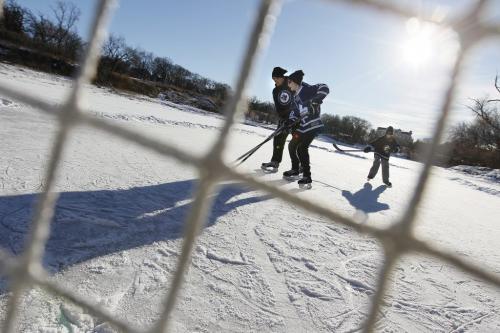 December 25, 2011 - 111225  -  Rob Finlay (L) plays hockey with his sons Matt (16) (C) and Chris (11) on the Assiniboine River Sunday, December 25, 2011.    John Woods / Winnipeg Free Press