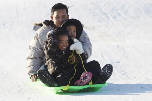 December 25, 2011 - 111225  - Max Gomez and his children Micaela (10) and Brian (5) are photographed sledding at garbage hill home Sunday, December 25, 2011.    John Woods / Winnipeg Free Press