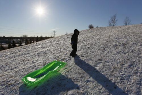 December 25, 2011 - 111225  -  Five year old Brian Gomez pulls his sled up garbage hill Sunday, December 25, 2011.    John Woods / Winnipeg Free Press