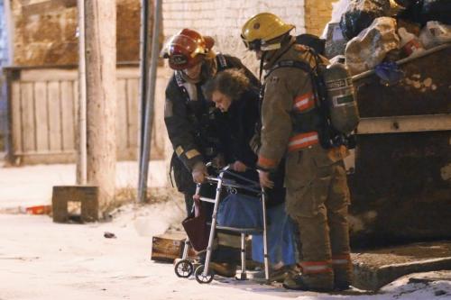 December 26, 2011 - 111226  -  Firefighters evacuate residents of an apartment block on Victor. Firefighters were called to an apartment fire at 351 Victor Monday, December 26, 2011. John Woods / Winnipeg Free Press