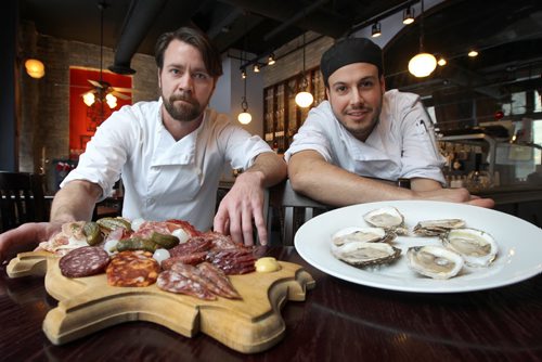 Peasant Cookery 100-283 Bannatyne Ave  Tristan Foucault, left, with Charcuterie ( a selection of house made sausages, pates, and terrines), and Chef de cuisine Chris Gama with Village Bay Oysters-See Marion Warhaft year restaurant column December 28, 2011   (JOE BRYKSA / WINNIPEG FREE PRESS)