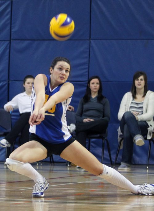 Brandon Sun 29122011 Jaryn Ruether #13 of the Brandon Bobcats digs the ball during Conferences of Canada Challenge tournament action against the McGill Martlets at the BU gymnasium on Thursday evening. (Tim Smith/Brandon Sun)