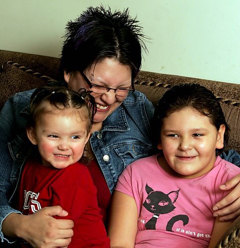 BORIS MINKEVICH / WINNIPEG FREE PRESS  070110 Verna Cowley and her daughters Misti,1, and Sydney,6, pose for a portrait in their Furby St. apartment.
