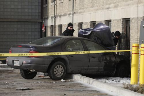 January 1, 2012 - 120101  - Fire inspectors investigate a collision where a car drove into the St Boniface Hospital Education Building at 431 Tache Sunday, January 1, 2012.  John Woods / Winnipeg Free Press