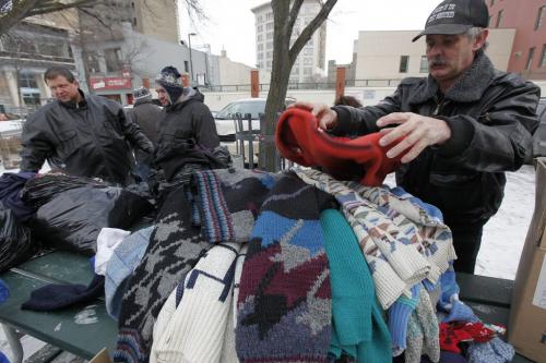 January 1, 2012 - 120101  - Ron Eldridge (R) and Gord Buczko (L) of Devoted To You Street Ministries distribute clothing to disadvantaged people in Market Square  Sunday, January 1, 2012.  John Woods / Winnipeg Free Press