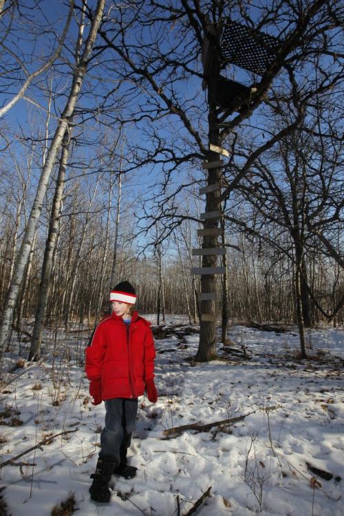 Eight-year-old Harley , in red, near the makeshift treehouse in the forest nearby his home. January 5, 2012 BORIS MINKEVICH / WINNIPEG FREE PRESS