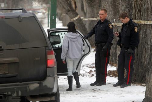 Police investigate a stabbing on spence street between ellice and sargent. Person of interest is put into the back of a squad car. January 10, 2012 BORIS MINKEVICH / WINNIPEG FREE PRESS