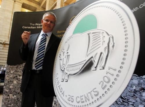 Royal Canadian Mint Senior Director Mark Neuendorff holds the new 25 cent piece with a Bison on it. The first of three 25-cent coins, announced last October as part of a series of 2011-dated commemorative circulation coins celebrating Canada's legendary nature, will circulate nation-wide on January 16, 2012 and the Royal Canadian Mint is hosting coin exchanges for the general public at its boutiques in Ottawa, Winnipeg and Vancouver. Half of the 12.5 million coins featuring this theme will be coloured, using the Mint's exclusive coin painting technology.  January 13, 2012 BORIS MINKEVICH / WINNIPEG FREE PRESS