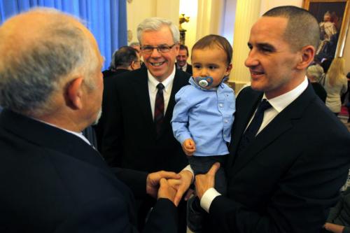 Manitoba Premier Greg Selinger with Manitoba newly appointed minister from Point Douglas MLA Kevin Chief, who becomes the minister of the new portfolio for children and youth opportunities. Chief is holding his kid  Hayden, 15 months. (no id on the man on the left) January 13, 2012 BORIS MINKEVICH / WINNIPEG FREE PRESS