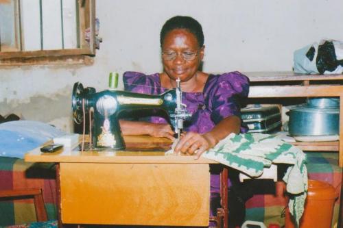 A grandmother in Uganda used funds raised in winnipeg's north end to buy a sewing machine. She is making clothes for a few extra dollars a week. chris penner photo mary agnes welch story / winnipeg free press