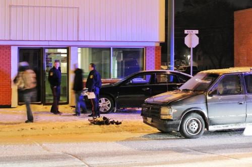 Police attend the scene of a two vehicle accident at 1411 Main Street at Atlantic Ave. where one of the cars hit the building causing damage.  120118 Mike Deal / Winnipeg Free Press