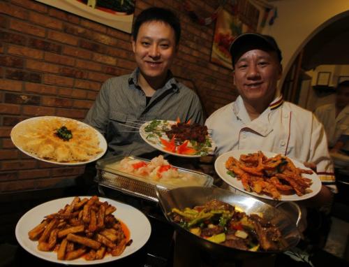 Yougot Chinese Restaurant Inc. owner Zhong Ren and head chef Yang Song with some dishes on the menu and specialty dishes not on the menu. January 18, 2012 BORIS MINKEVICH / WINNIPEG FREE PRESS
