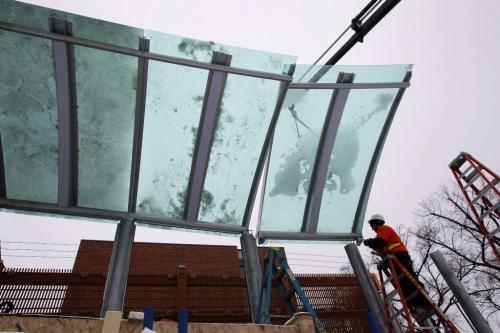 Workers install some glass panels in the Osborne Rapid Transit station.  January 22, 2012 BORIS MINKEVICH / WINNIPEG FREE PRESS