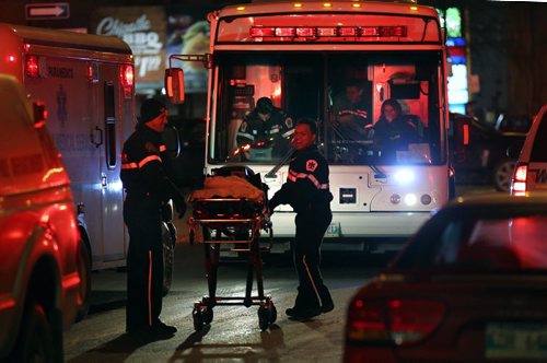 Paramedics, ambulances stand by as fire crews work on a fire in City Place Parcade Wednesday evening at Graham and Donald.. January 25, 2012 - (Phil Hossack / Winnipeg Free Press)
