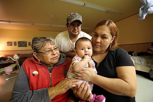 Family makes their home in a old fitness centre on Ebb and Flow First Nation after being displaced due to spring flooding of Lake Manitoba.  Adequate housing is a problem on the reserve especially with last years flood. Names - Anne Houle (mother in law, left). Frank Houle (her son), Rachel Govereau (daugter in law) with Trinity Houle - 4 month old (Frank and Rachel's daughter).  See Mary Agnes Welch story on Ebb and Flow First Nation. Jan 25, 2012 (Ruth Bonneville /  Winnipeg Free Press)