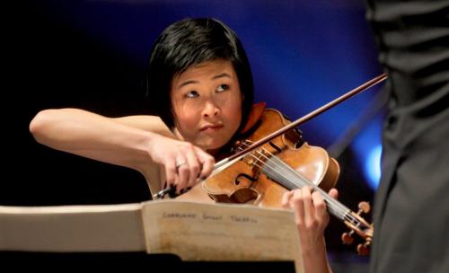 Violin soloist Jennifer Koh waits for her cue from the conductor as she performs at the opening gala for the 21st annual New Music Festival at the Concert Hall Saturday evening.  Jan 28, 2012 (Ruth Bonneville / Photographer) Winnipeg Free Press