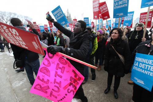 University of Winnipeg student Mathew Joseph (pink sign) along with hundreds of post secondary students rally together at the Leg Wednesday afternoon for a freeze on tuition fee's. Feb 01, 2012 (Ruth Bonneville / Photographer) Winnipeg Free Press