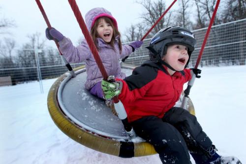Five year old Naomi Frank and her little brother Marty 3yrs scream for joy as they play on the swing at the children's park at Assiniboine Park Wednesday afternoon while hanging out with mom and their little baby brother. Standup photo Feb 02, 2012 (Ruth Bonneville / Photographer) Winnipeg Free Press