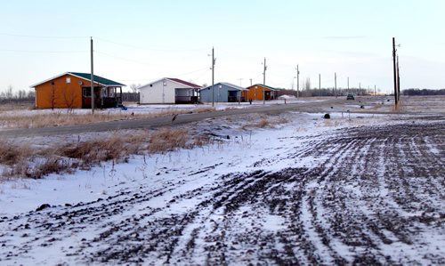 A picturesque row of log homes with tin roofs are being built on Swan Lake First Nation to ensure longevity. See Mary Agnes Welch Swan Lake Story. Feb 03, 2012 (Ruth Bonneville / Winnipeg Free Press)