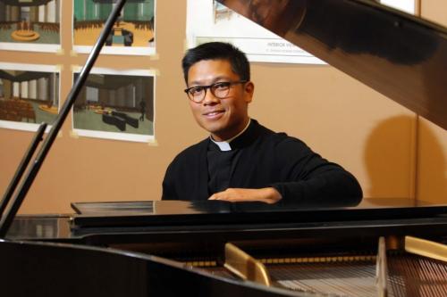 FAITH - Geoffrey Angeles is a priest of the Archdiocese of Winnipeg, currently serving the parishes of Sacred Heart (Virden). Here he poses with a piano. He wrote some music that will be used across Canada in Catholic churches. Photo taken in Winnipeg.  REPORTER: Brenda Suderman  February 6, 2012 BORIS MINKEVICH / WINNIPEG FREE PRESS