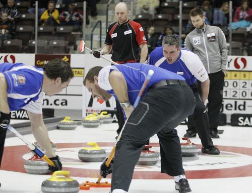 February 12, 2012 - 120212  -  Allan Lyburn, 3rd for Allan Lyburn, yells at his sweepers as they curl in the Safeway Championship against Mike McEwen (R) and BJ Neufeld in Dauphin Sunday February 12, 2012.    John Woods / Winnipeg Free Press