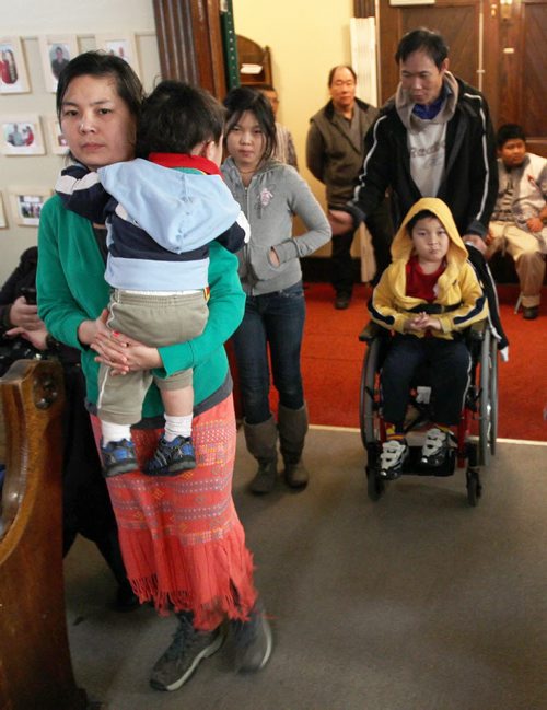 Burmese family that had trouble with Child and Family Services at City Church 484 Maryland. Front  mother K'dah Ra Wah holding Thaehna Say , daughter Buna Bel, and father Shwe La Say with Blessing Saw in wheelchair  -   see Lindor Reynolds FYI story- February 14, 2012   (JOE BRYKSA / WINNIPEG FREE PRESS)