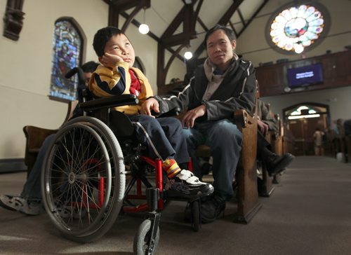 Burmese family that had trouble with Child and Family Services at City Church 484 Maryland. Father Shwe La Say with Blessing Saw in wheelchair -   see Lindor Reynolds FYI story- February 14, 2012   (JOE BRYKSA / WINNIPEG FREE PRESS)